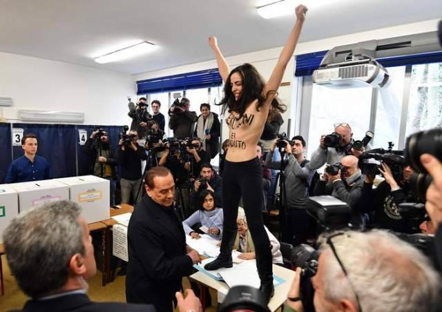 ELEZIONI: BERLUSCONI CONTESTATO AL SEGGIO DA DONNA A TORSO NUDO